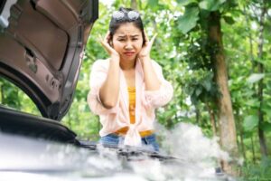 What should you do if you encounter a car that is overheating